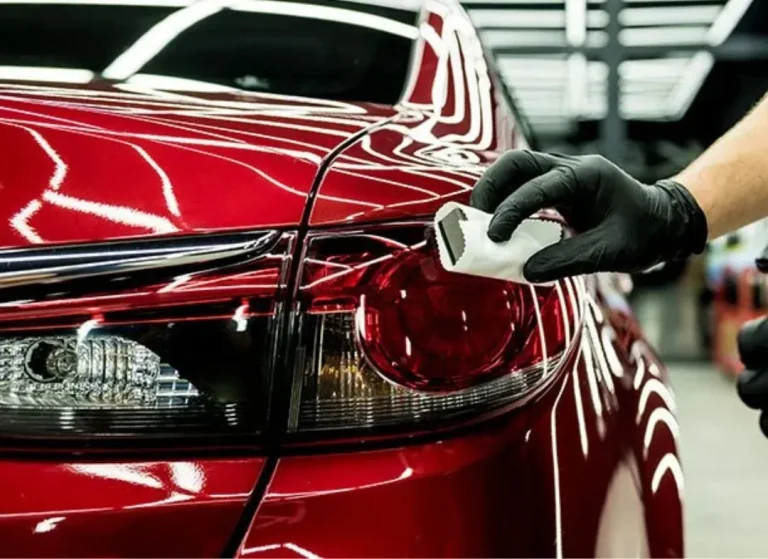 Applying ceramic coating to car.